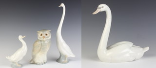 A Lladro figure of a swan 20cm, a Nao figure of a goose 30cm, 1 other 15cm and an owl 17cm