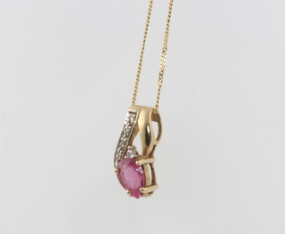 A 9ct yellow gold ruby and diamond pendant on a ditto chain 