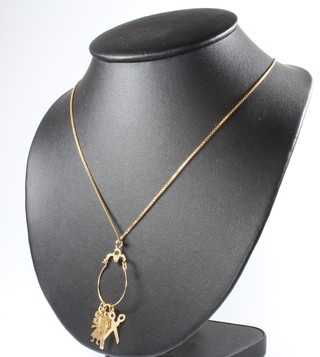 A 9ct yellow gold necklace and charms, 9 grams
