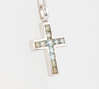 An 18ct white gold sapphire set cross and chain 