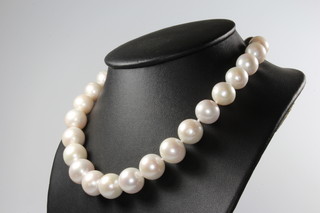 A string of cultured pearls with a silver magnetic barrel clasp 45cm 