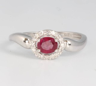 A 9ct white gold oval ruby and diamond ring, the centre stone approx. 0.5ct size N 