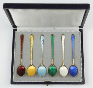 Six silver gilt guilloche enamel coffee spoons with spiral  handles in a fitted case 