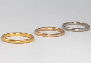 A 22ct yellow gold wedding band size P 3.4 grams, an 18ct ditto size L 2.3 grams and a 9ct ditto size L 1.8 grams 