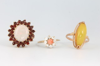 A 9ct yellow gold opal and garnet ring size P, a dress ring size O and a coral set ditto size L 