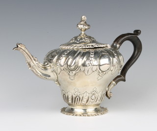 A Victorian repousse silver melon teapot with beaded decoration and chased armorial having ebony handle, London 1887, maker Frederick Bradford Mactea gross 588 grams