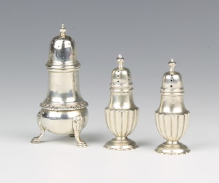 A pair of Edwardian silver pepperettes Birmingham 1903, 7cm and a larger ditto, 85 grams