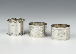 A pair of silver napkin rings with chased decoration Birmingham 1913, 1 other, 83 grams