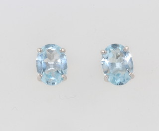 A pair of silver blue topaz studs