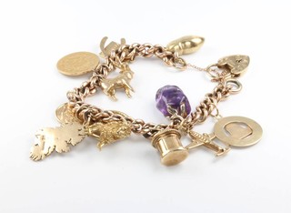 A 9ct yellow gold charm bracelet and charms including a gold 10 franc coin 1856, gross including an amethyst charm 49 grams 