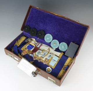 A Masonic briefcase containing an apron, 2 sashes and minor jewels 