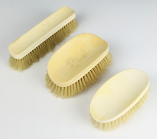 A pair of 1930's ivory backed brushes and a ditto clothes brush 