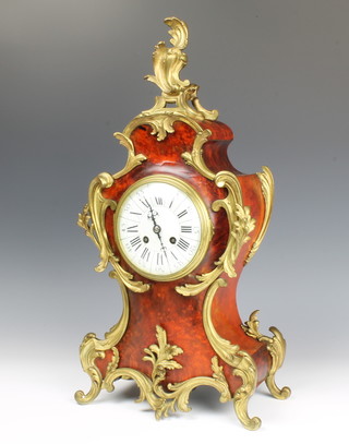 Japy, a 19th Century French 8 day striking mantel clock with porcelain dial contained in a "tortoiseshell" shaped case with gilt metal mounts, complete with key, pendulum and bell, the back plate marked 37106 
