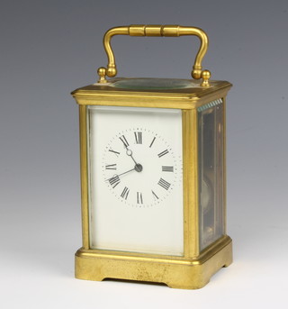 A French 19th Century 8 day striking carriage clock with enamelled dial contained in a gilt metal case, the back plate marked 265 (no key) 