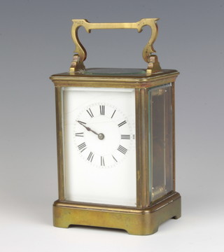 A 19th Century French 8 day carriage timepiece with enamelled dial and Roman numerals contained in a gilt metal case 13cm x 9cm x 8cm 