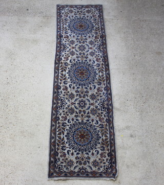 A Persian blue and white ground Nir runner with 3 medallions to the centre 288cm x 79cm
