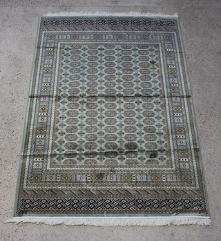 A green ground Bokhara style Belgian cotton rug with numerous octagons to the centre within a multi row border 230cm x 160cm  