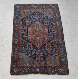 A brown and blue ground Malayer rug with diamond shaped central medallion within a multi row border 207cm x 130cm 