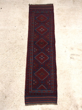 A blue and red Meshwani runner with 5 octagons to the centre within a multi row border 250cm x 63cm 