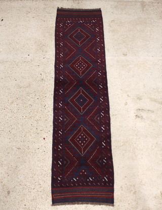 A red and blue ground Meshwani runner with 4 stylised diamonds to the centre within multi row borders 253cm x 61cm 