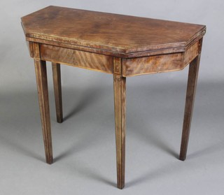 A Georgian shaped mahogany tea table raised on square tapered supports 74cm h x 91cm w x 45cm d 
