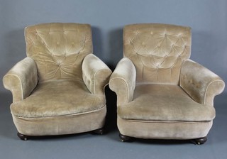 A pair of Victorian Howard style armchairs upholstered in mushroom buttoned back material, raised on bun feet 80cm h x 91cm w x 80cm d 