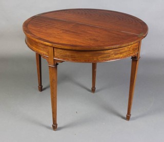 An Edwardian inlaid demi-lune tea table, the top inlaid and crossbanded and raised on 4 square tapered supports, spade feet 71cm x 91cm x 45cm 