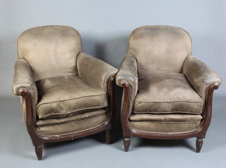 A pair of French style armchairs upholstered in "suede" material raised on turned supports 