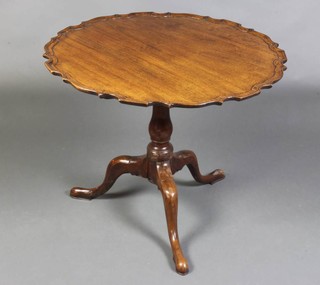 A Chippendale style circular tea table with pie crust edge raised on pillar and tripod base 60cm x 74cm, the base has an iron plate repair