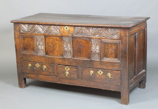 A 17th/18th Century carved oak mule chest with hinged lid formed of 3 planks, heavily carved to the front and iron lock, the base fitted 1 long and 2 short drawers, marked TL, 78cm h x 143cm w x 62cm