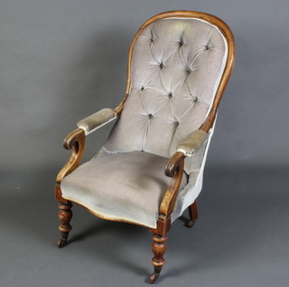 A William IV mahogany show frame open arm chair upholstered in mushroom buttoned velvet, raised on turned supports 