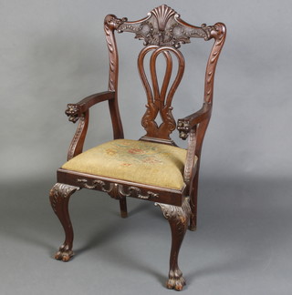 An Edwardian Chippendale style carved mahogany open armchair with pierced vase shaped slat back upholstered drop in seat and lion mask arm, raised on cabriole ball and claw supports  