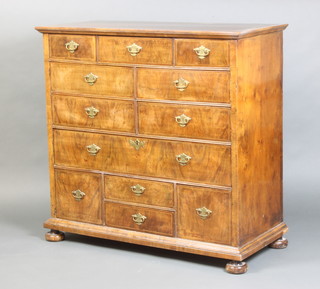A Queen Anne figured walnut chest with quarter veneered crossbanded top above an arrangement of 7 short and 1 long drawers, the base fitted 4 short drawers, raised on replacement bun feet, (formerly the top of a chest on stand or chest) 95cm h x 99cm w x 44cm d 
