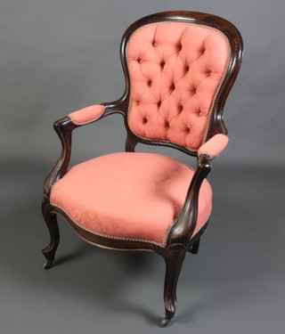 A Victorian beech framed open arm chair with upholstered seat and back raised on cabriole supports 