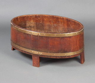 A Georgian oval mahogany and brass banded wine cooler raised on shaped supports 37cm h x 76cm w x 49cm d 