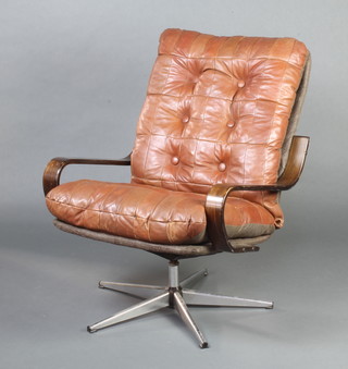 A 1960's chrome and leather revolving open arm chair 