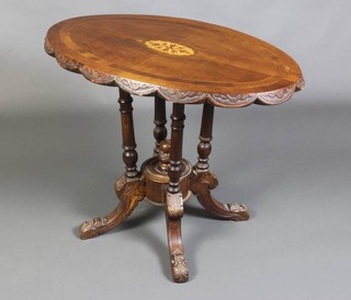 A Victorian oval carved and inlaid Loo table with quarter veneered top raised on 4 turned columns 65cm h x 82cm l x 52cm w 