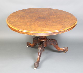 A Victorian circular figured walnut snap top breakfast table with quarter veneered top raised on a turned column and tripod base 73cm x 118cm diam. 