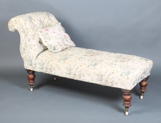 A Victorian chaise longue upholstered in buttoned tapestry fabric raised on turned supports 79cm h x 147cm w x 57cm d 
