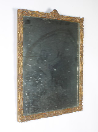 A rectangular plate wall mirror contained in a Rococo style gilt plaster frame 58cm x 45cm 