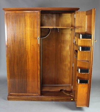 A 1930's mahogany compactum wardrobe enclosed by panelled doors and raised on a platform base 168cm h x 127cm w x 54cm d 
