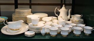 A 110 piece Royal Albert Val D'or pattern dinner service comprising oval meat plate (2nd), sauce boat and stand (2nd), 13 dinner plates (all 2nds), 12 side plates (all 2nds), 11 tea plates (3 2nds), 8 soup bowls (5 2nds), 10 pudding bowls (2 2nds), 2 twin handled soup bowls, 3 butter dishes, 7 coffee cups (all 2nds), 9 saucers (all 2nds), coffee pot (2nd), cream jug, lidded sugar bowl (2nd), pepper pot, milk jug and sugar bowl (both 2nds), 13 tea cups (1 2nd) and  12 saucers  