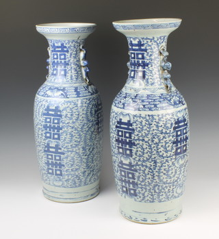 A near pair of 18th Century style Chinese blue and white vases with stylised dragon handles decorated with scrolling flowers 58cm and 59.5cm 