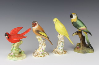 Two Royal Worcester figures Red Crest 2667 16cm and Canary 2665 16cm and 2 Crown Staffordshire figures - Cardinal by J T Jones 13cm and a Macaw 20cm
