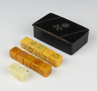 A rectangular 19th Century snuff box with hinged lid containing 2 square carved ivory dice and 10 gaming dice 