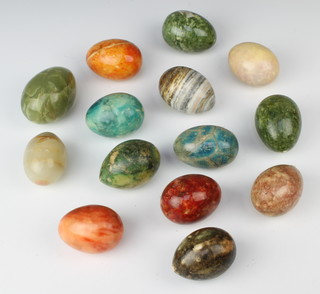 14 various hardstone eggs contained in an oval basket 