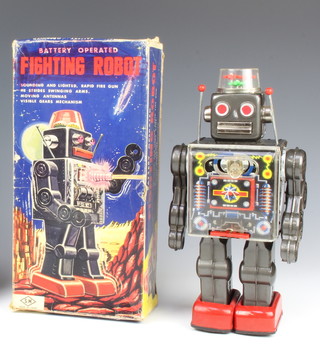 A 1960's Horikawa Japanese battery operated fighting robot, boxed. The robot is dark grey  lithographed tin plate, height 28cm