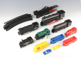 A Chinese O gauge, plastic battery operated locomotive, 2 OO gauge clockwork locomotives and a small collection of rails etc 