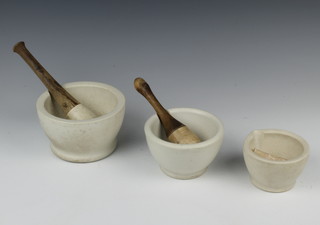 A Wedgwood mortar and pestle 9cm x 15cm (chip to rim), one other mortar and pestle 8cm x 13cm and one other 7cm x 10cm 
