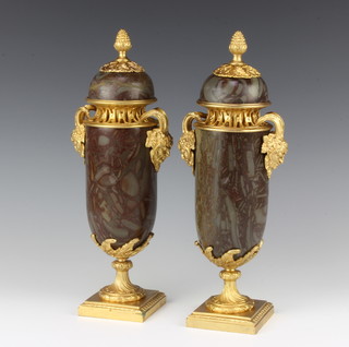 A pair of Continental veined marble urns and covers with gilt ormolu mounts, raised on square bases 31cm x 8cm x 7cm 